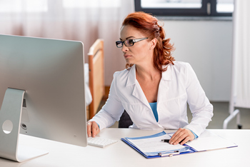An underwriter looking at her computer screen